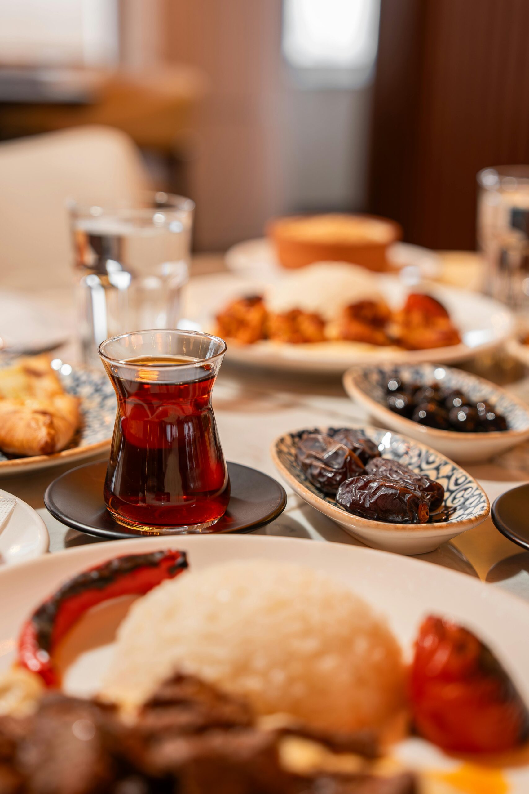 A variety of Turkish breakfast dishes with a glass of tea, showcasing regional culinary culture in Ünye, Ordu.